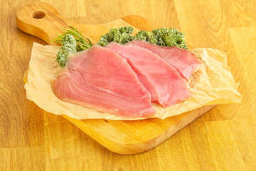 Raw salted tuna slice over board
