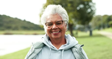 Smile, nature and face of senior woman with confidence for retirement vacation with outdoor exploring. Happy, pride and elderly female person from Colombia in park, garden or field with wind.