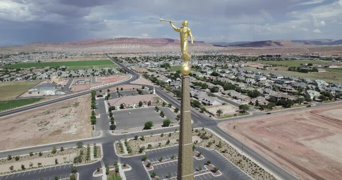 Angel Moroni Statue On Red Cliffs Latter-day Saints Mormon Temple, Utah. Tracking Aerial Shot