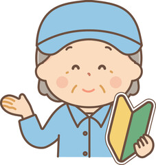 初心者マークを持って案内する作業服のシニア女性
