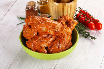 Raw turkey shoulder wing in Indian tandoori marinade