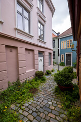 Charming alleyway with cobblestone path in old town in Bergen, Norway