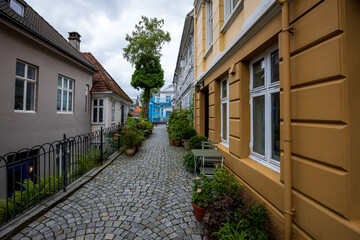 Narrow cobblestone street in charming old town in Bergen, Norway