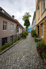 Narrow cobblestone street in charming old town in Bergen, Norway