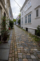 Charming old town alley with cobblestone path in Bergen, Norway