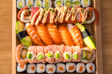 Assorted sushi with nigiri, rolls, and fresh ingredients in a cardboard box for delivery 