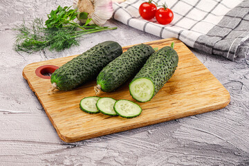Raw green cucumbers with slices