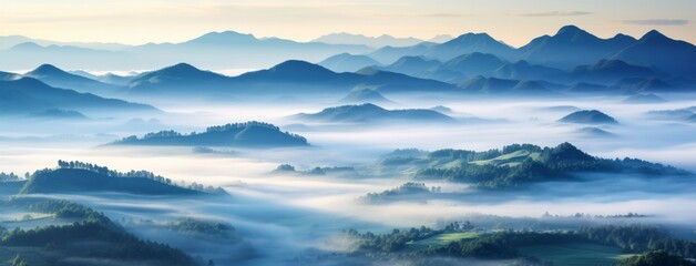 A breathtaking view of misty mountains with layers of fog rolling over the lush green hills and peaks in the background.