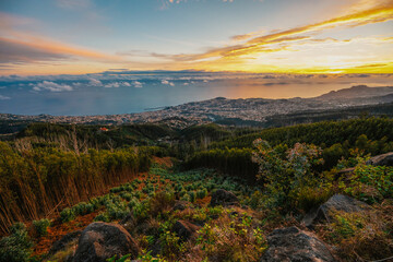 beautiful sunset over the city of Funchal on Madeira from the location Miradouro do Pico Alto. Mountains landscape
