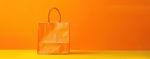 A yellow background with a shopping bag and leaves. Free copy space for text.