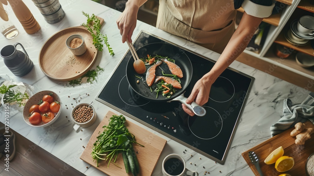 Poster Top view of a modern kitchen setup with a person cooking salmon. Healthy cooking concepts and kitchen lifestyle. This image showcases fresh ingredients and a stylish, organized kitchen environment. AI