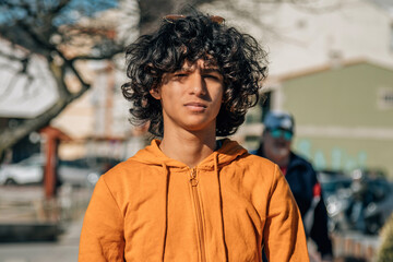 young man with doubt or hesitant gesture on the street