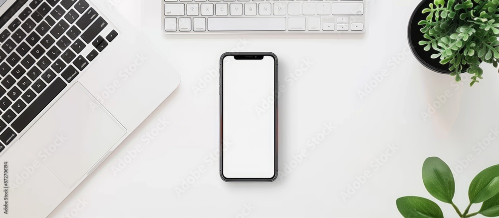 Poster Minimal workspace with smartphone and laptop on a white desk seen from above, featuring a blank screen ready for use as a copy space image.