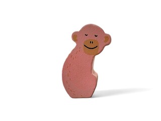 Wooden decoration with a pink monkey character on a white background