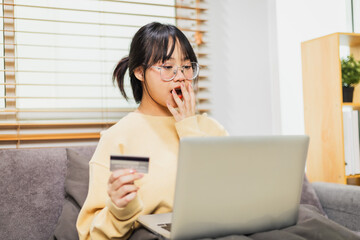 The joy of shopping online with a credit card on her laptop at home.