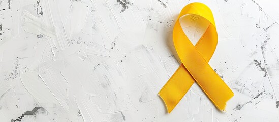 Commemorate Childhood Cancer Day with a yellow ribbon set against a white backdrop, perfect for inclusion in a layout with copy space image.
