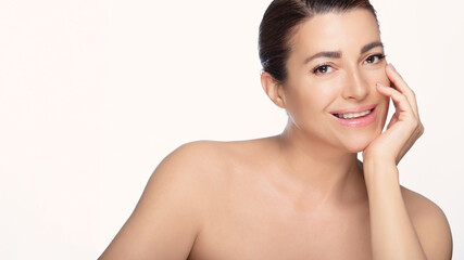 Smiling natural 50's woman with flawless skin posing for skincare advertisement