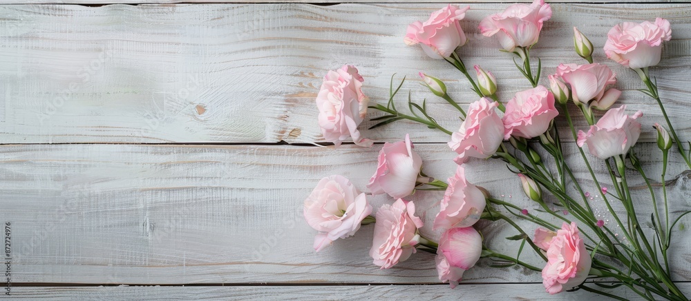 Leinwandbilder Pink eustoma flowers are arranged on a wooden backdrop to create a charming display with copy space image.