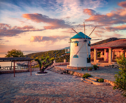 Attractive morning view of Potamitis Windmill. Stunning summer sunrise on Zakynthos island, Korithi location, Ionian Sea, Greece, Europe. Traveling concept background.