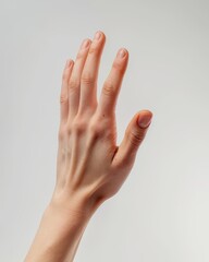Close-up of a person's hand reaching up with a neutral background. Perfect for concepts of help, request, or gesture.