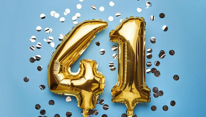 Banner with number 41 golden balloon. 41 years anniversary celebration. Blue background. Close-up.