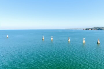 Fototapeta premium Majestic offshore wind turbine standing tall in the vast and serene ocean landscape