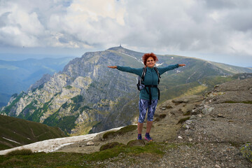 Woman hiking in the mountains with backpack
