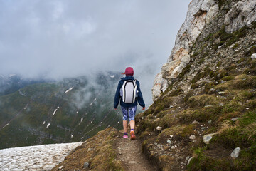 Woman hiker in a rainy day in the mountains