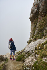 Fototapeta premium Woman hiker in a rainy day in the mountains