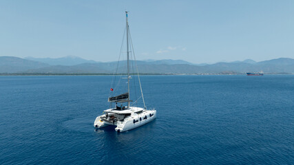 Aerial drone photo of beautiful catamaran sailing yacht anchored in tropical exotic turquoise sea...