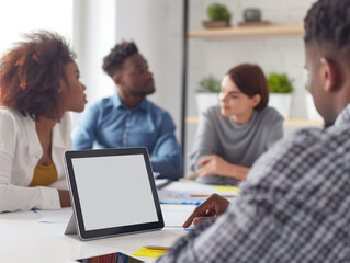 Fototapeta premium Group of Diverse Students or Coworkers Using Tablet with White Screen in Meeting, Corporate Data Mockup, DEIB, DEI, Brainstorm, Presentation Concept.