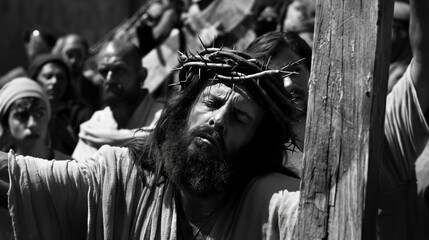 Jesus wearing a crown of thorns, carrying the cross surrounded by followers in a black and white scene. Religious depiction, Easter, biblical story, crucifixion, Christian faith.