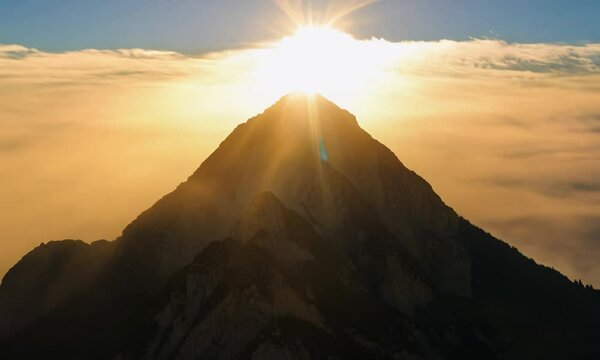 The peak of a sacred mountain illuminated by the glow of the sun: perfect for religious or inspirational themes. This view is not only picturesque, but also filled with spiritual meaning.	