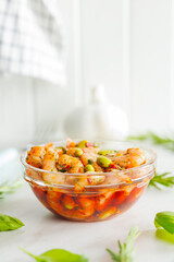 Fresh salad with shrimps and edamame soybeans in bowl on white table.