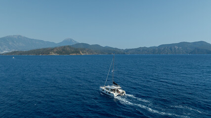 Aerial drone photo of beautiful catamaran sailing yacht anchored in tropical exotic turquoise sea...
