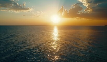 Obraz premium Beautiful sunset over the ocean with a blue sky, scenic view, calm seawater, drone aerial shot