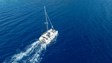 Fototapeta premium Aerial drone photo of beautiful catamaran sailing yacht anchored in tropical exotic turquoise sea exotic bay