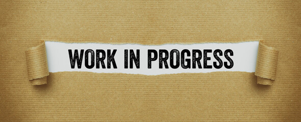 Torn paper revealing the words Work in progress