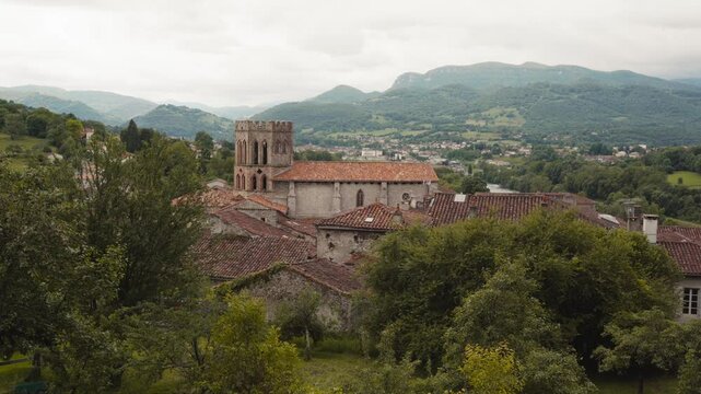 Profile view of Cathedral of Saint Lizier and Pyrenees at  background in Occitanie, France.
