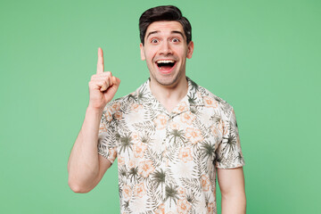 Young insighted smart surprised fun proactive man he wear shirt casual clothes holding index finger up with great new idea isolated on plain pastel green background studio portrait. Lifestyle concept.