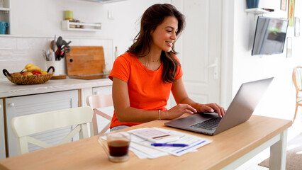 Young woman working online at her home office