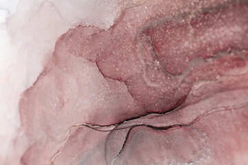 A close-up of an abstract painting featuring swirling, overlapping shades of pink and white ink