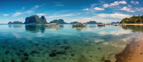 Obraz premium Tranquil Lagoon with Boats and Mountainous Islands