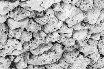 Black and white abstract background of stone rocks wall closeup