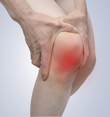 Close Up of Hand Holding Knee with Knee Pain Due to Degenerative Arthritis