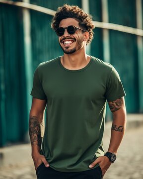 Smiling man in a green t-shirt and sunglasses walking in an urban setting