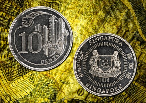 Close-up of Singapore 10 cents coin from 2014 on a yellow textured background