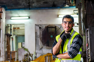 Caucasian engineer mechanic man checking for maintenance pressing metal machine by laptop at factory, worker at industrial concept	
