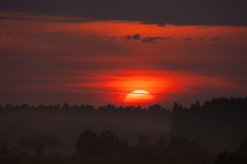 Obraz premium summer evening, sunset in yellow, orange and pink with clouds, background