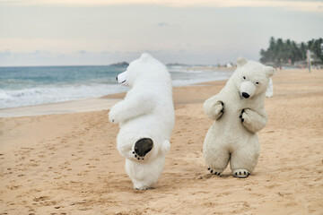 Animators dressed as polar bears entertain people on the beach. High quality photo